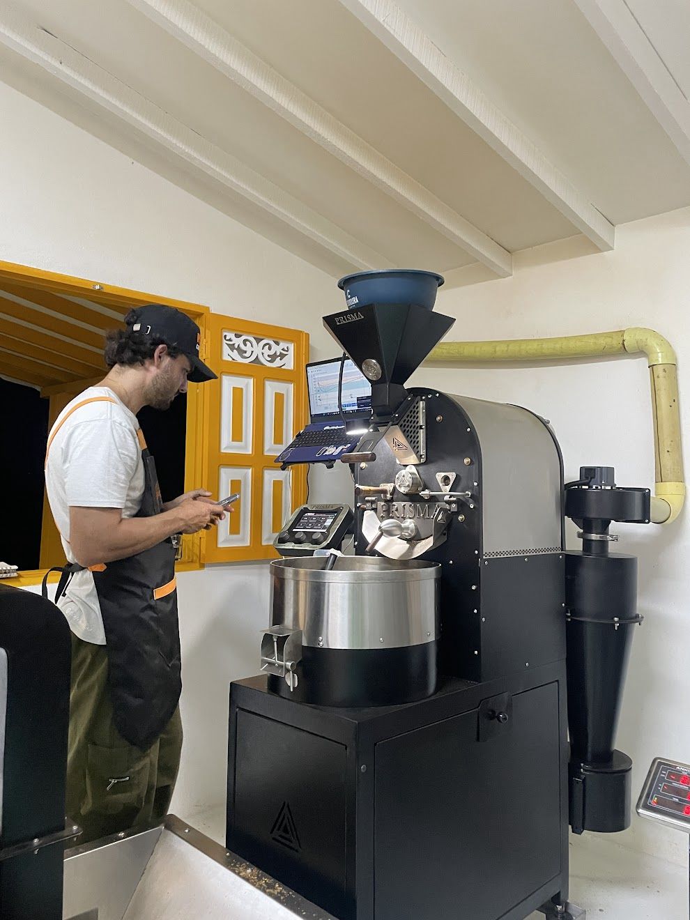 Roaster tending the Prisma coffee roaster